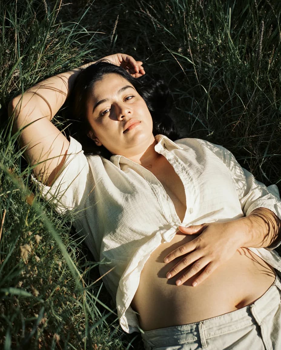 A woman lying in tall grass